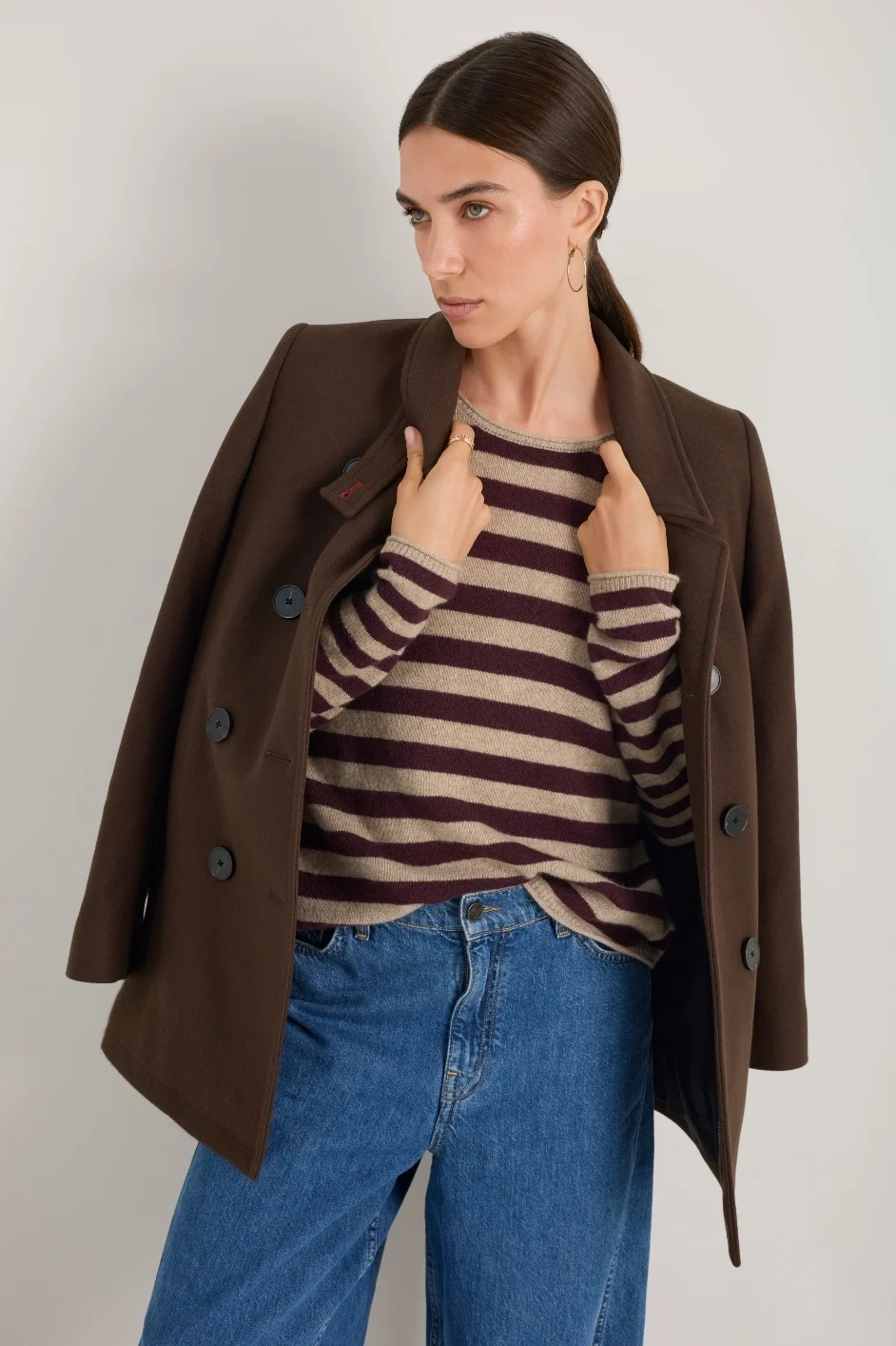 Chocolate Brown Double-Breasted Coat with a Striped Top and Jeans