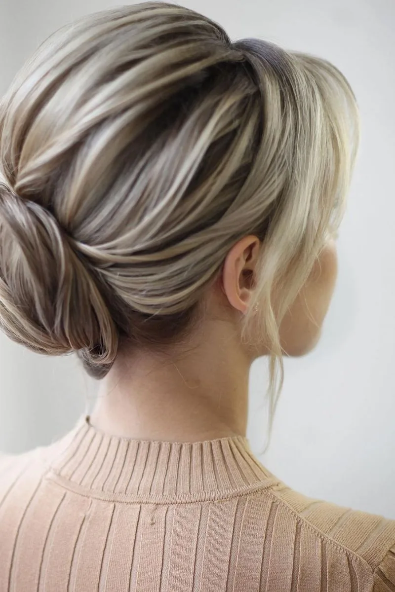Sleek Low Bun with Blonde Accent Pieces