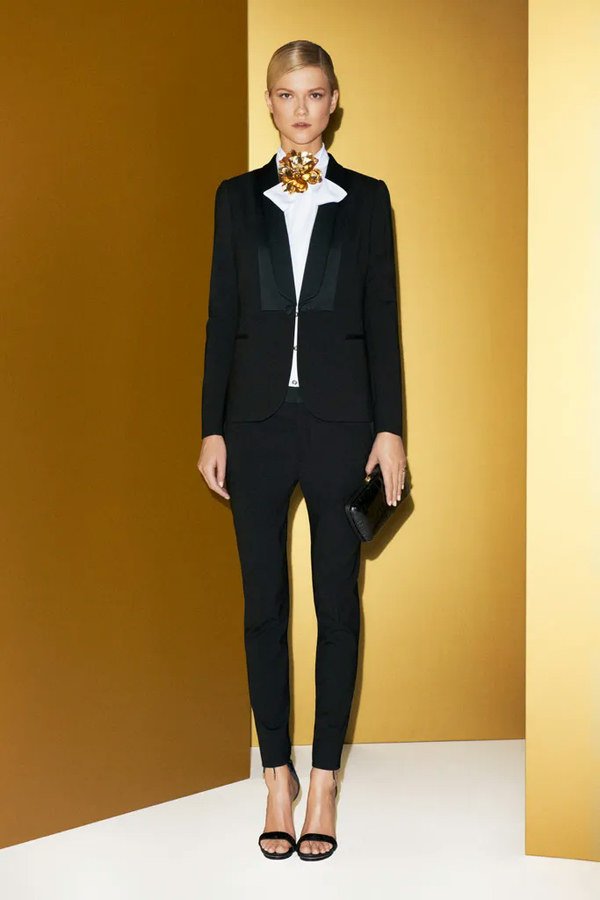 Black Tuxedo Suit with a Gold Statement Necklace and a Clutch