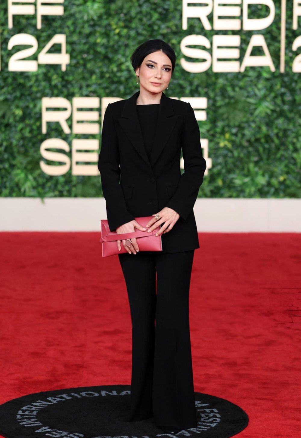 Black Tuxedo Suit with a Red Clutch and Flared Trousers