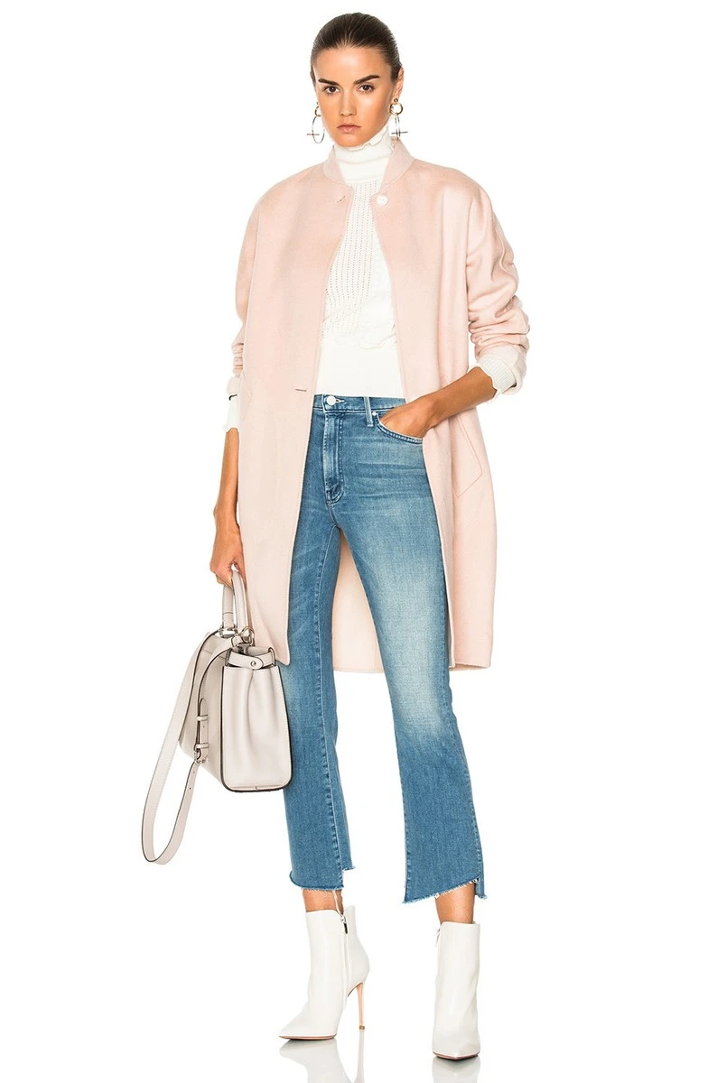 Pale pink coat and jeans outfit with leather ankle boots and silver drop earrings