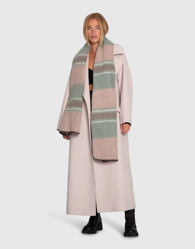 Soft pink wool coat outfit with black trousers, leather ankle boots and a silk scarf