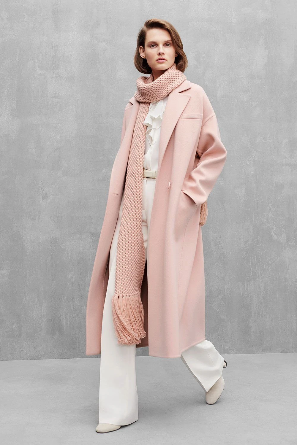 Soft pink coat and trouser outfit with smart loafers and a silk scarf