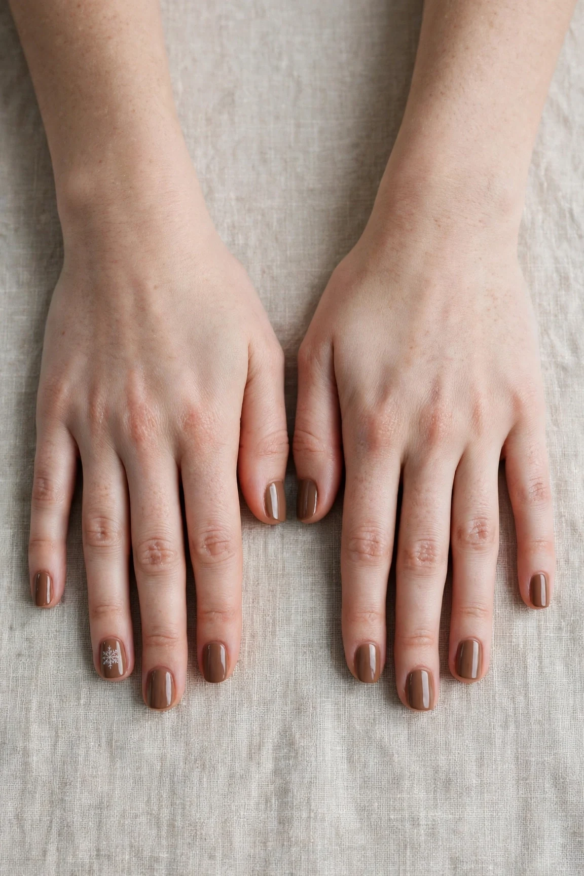30 Brown Neutral Christmas Nails For Women In Their 20S With Short Square Nails That Are Chic, Warm and Elegant 26 Brown Neutral Christmas Nails with a high-gloss finish and a delicate snowflake on the ring finger