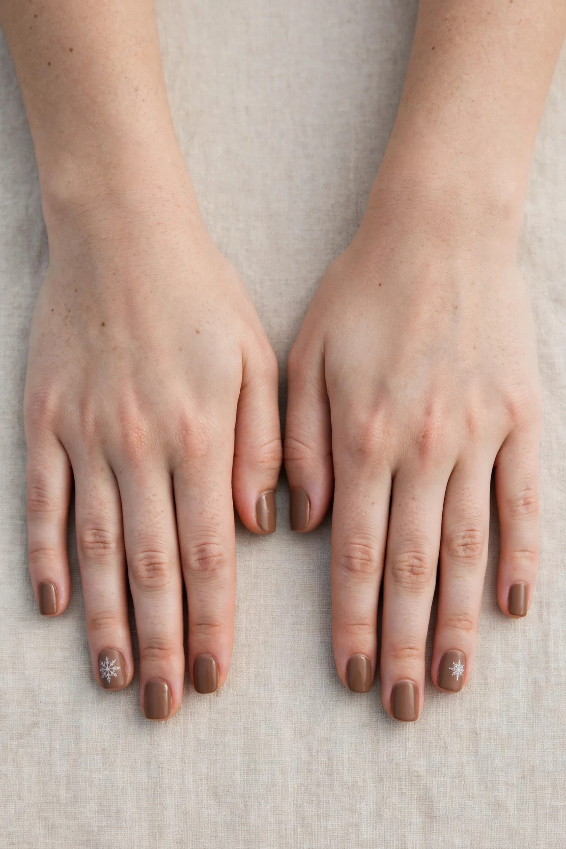 30 Brown Neutral Christmas Nails For Women In Their 20S With Short Square Nails That Are Chic, Warm and Elegant 27 Brown Neutral Christmas Nails with a soft matte finish and a delicate snowflake on the ring finger