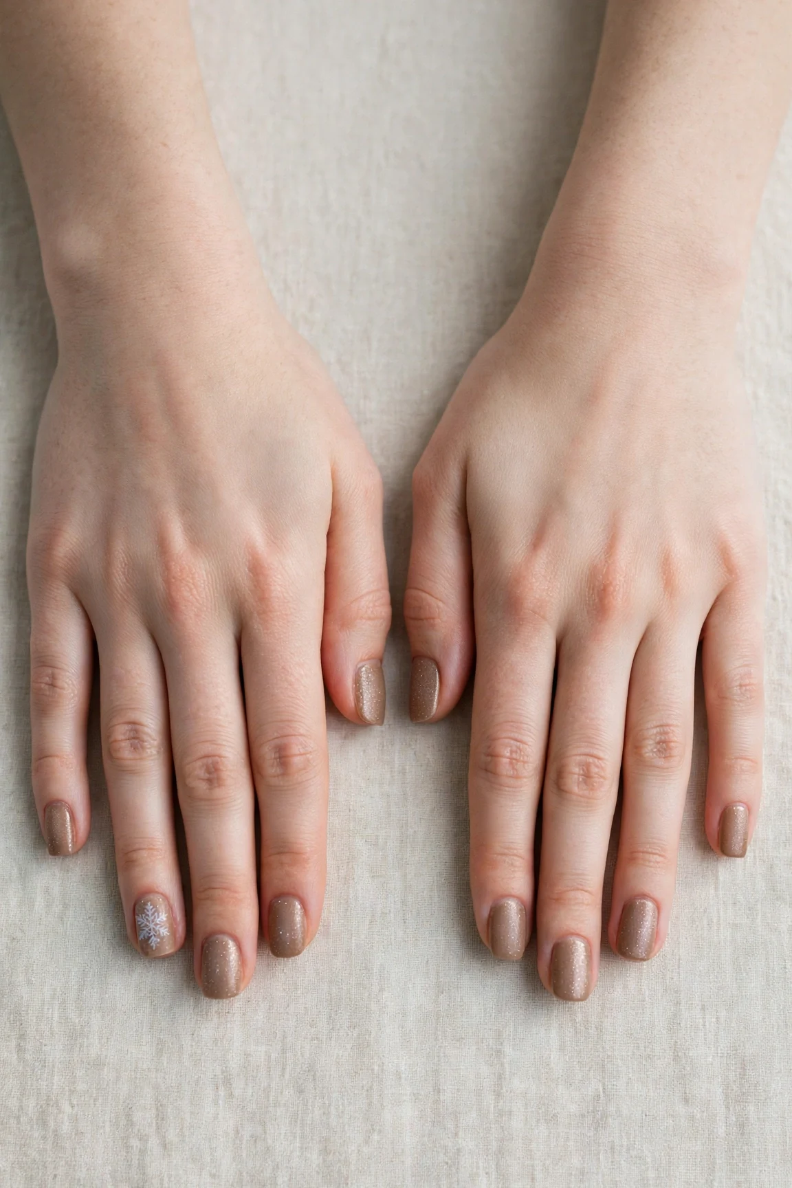 30 Brown Neutral Christmas Nails For Women In Their 20S With Short Square Nails That Are Chic, Warm and Elegant 31 Brown Neutral Christmas Nails with a frosted shimmer finish and a delicate snowflake on the ring finger