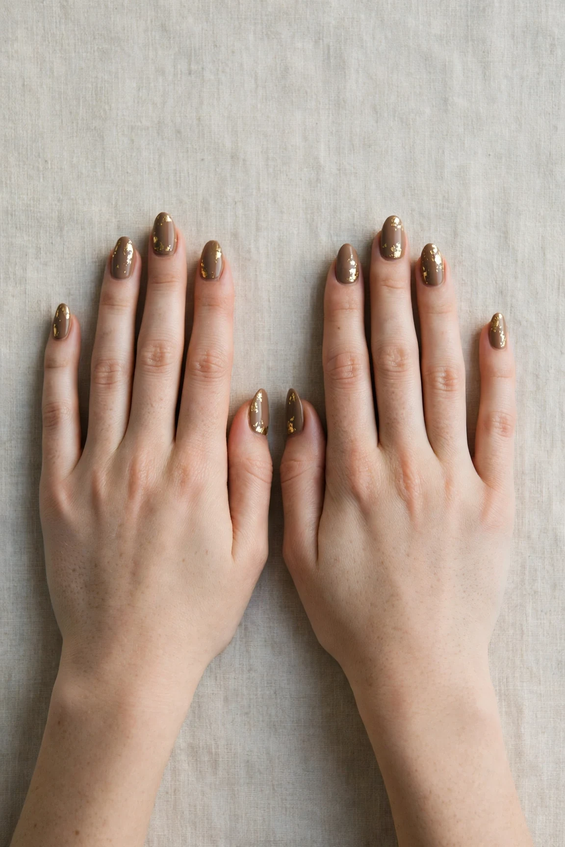 Almond Brown Neutral Matte Christmas Nails with a soft matte finish and gold foil accents