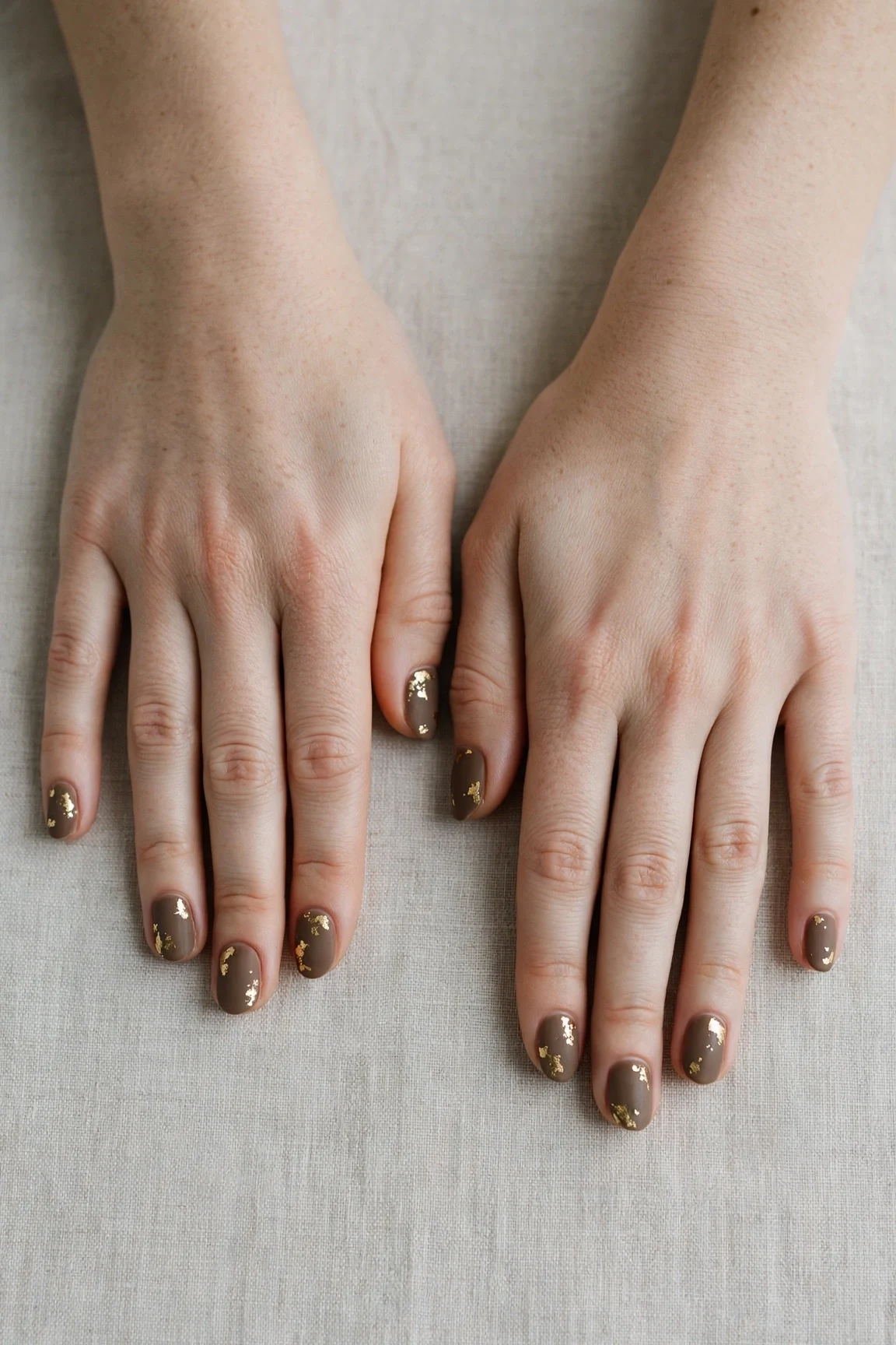 Oval Brown Neutral Matte Christmas Nails with a velvet matte finish and gold foil accents