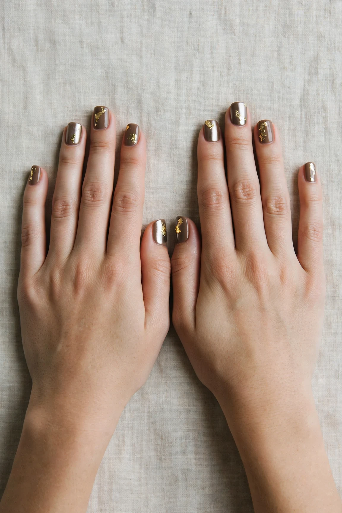 Short Square Brown Neutral Matte Christmas Nails with a chrome shine and gold foil accents