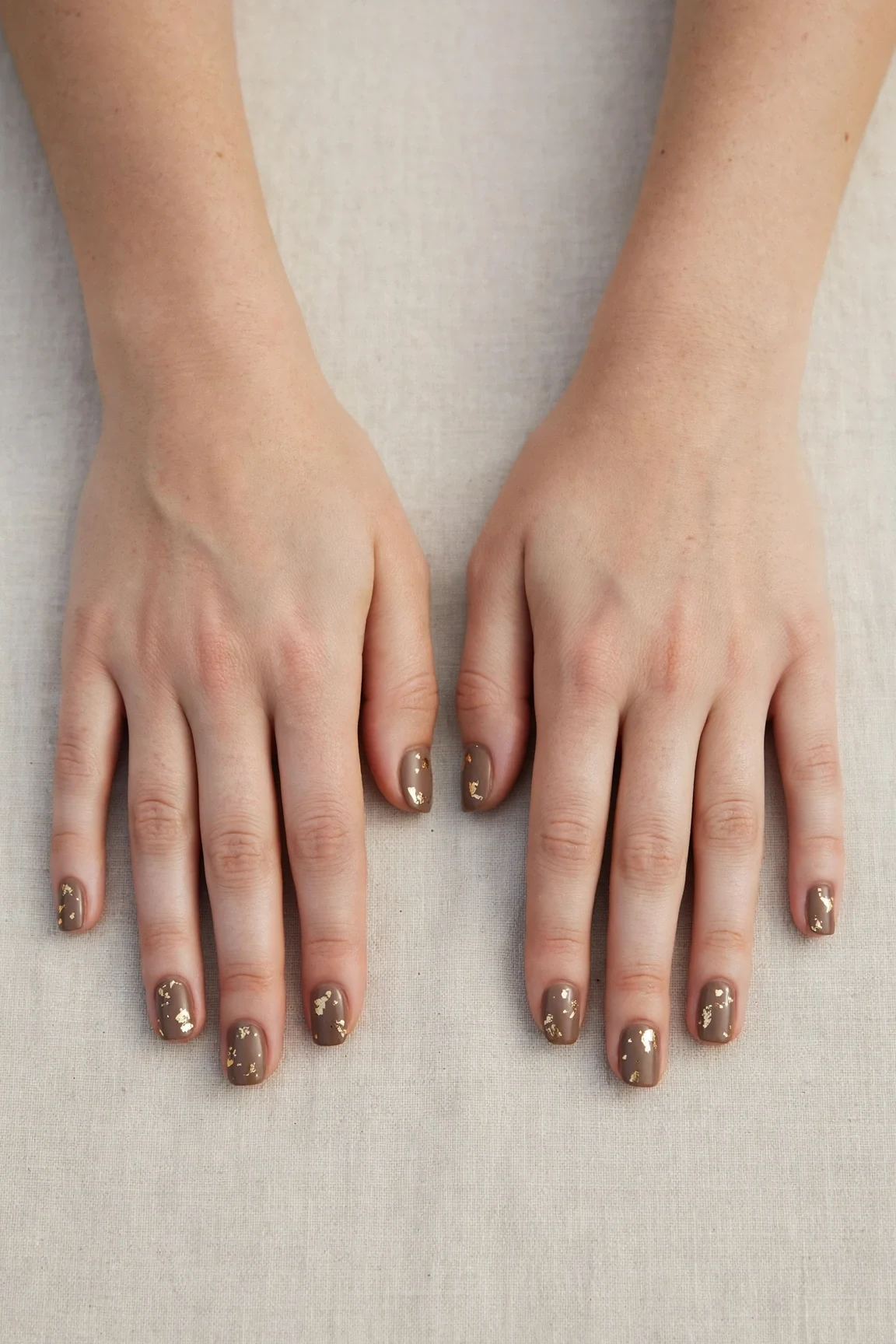 Squoval Brown Neutral Matte Christmas Nails with a creamy opaque finish and gold foil accents