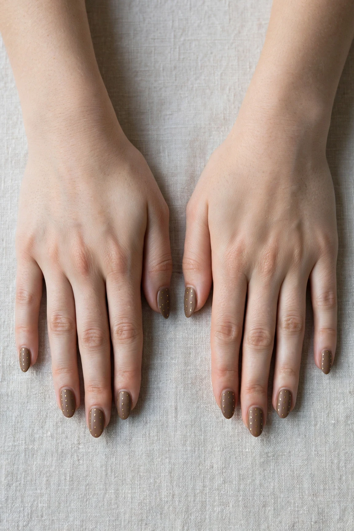 Almond Brown Neutral Matte Christmas Nails with a soft matte finish and tiny gold dots