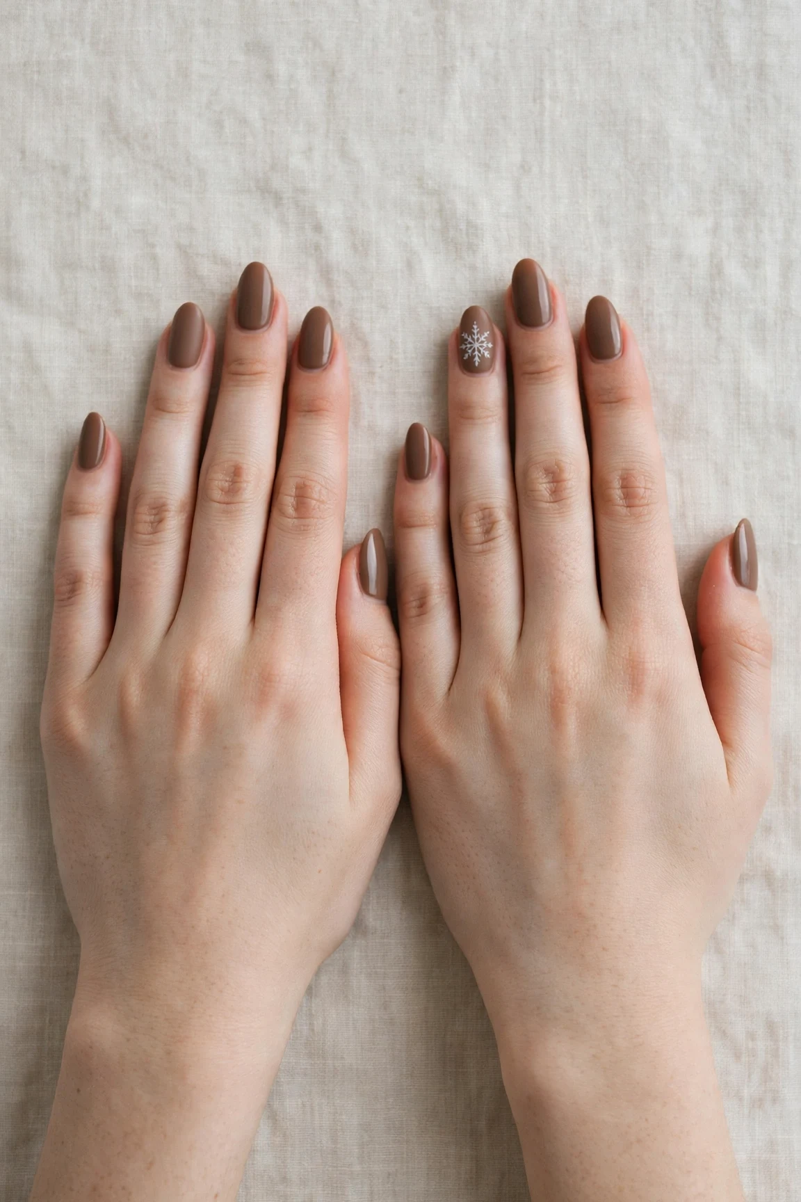 Almond Brown Neutral Matte Christmas Nails with a soft matte finish and a delicate snowflake on the ring finger