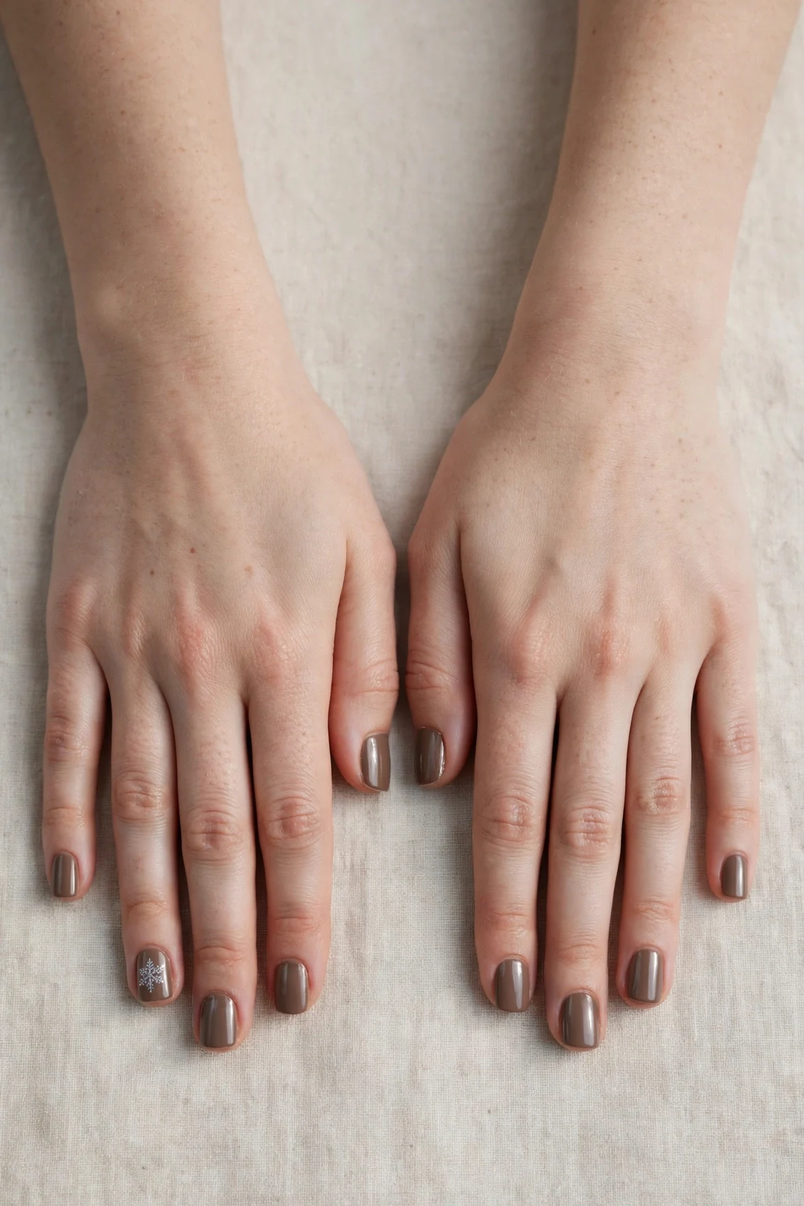 Short Square Brown Neutral Matte Christmas Nails with a chrome shine and a delicate snowflake on the ring finger