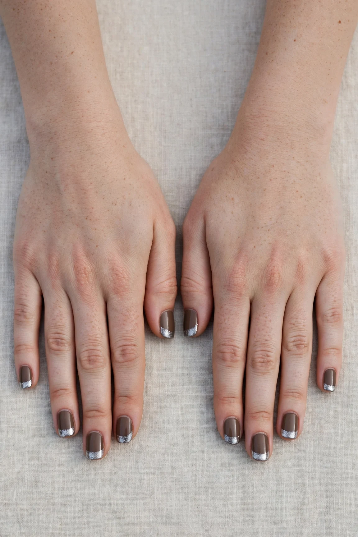 Short Square Brown Neutral Matte Christmas Nails with a chrome shine and silver shimmer tips