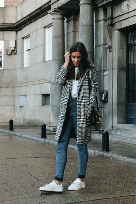 Checked Wool Coat Over a White Shirt and Blue Jeans
