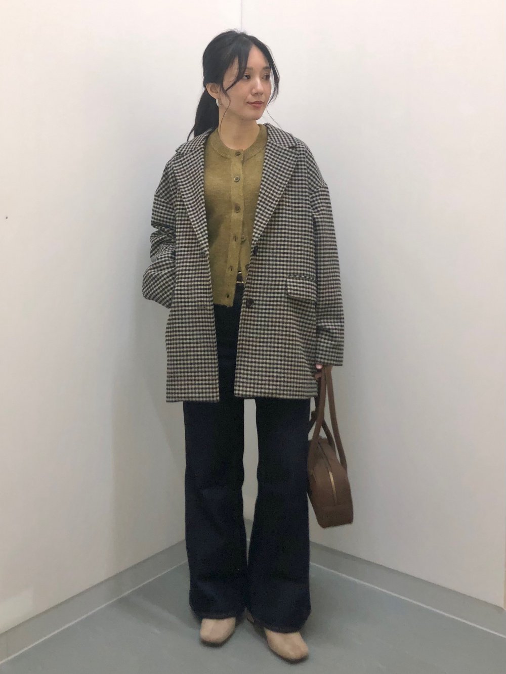 Checked Wool Coat Over an Olive Jumper and Dark Jeans