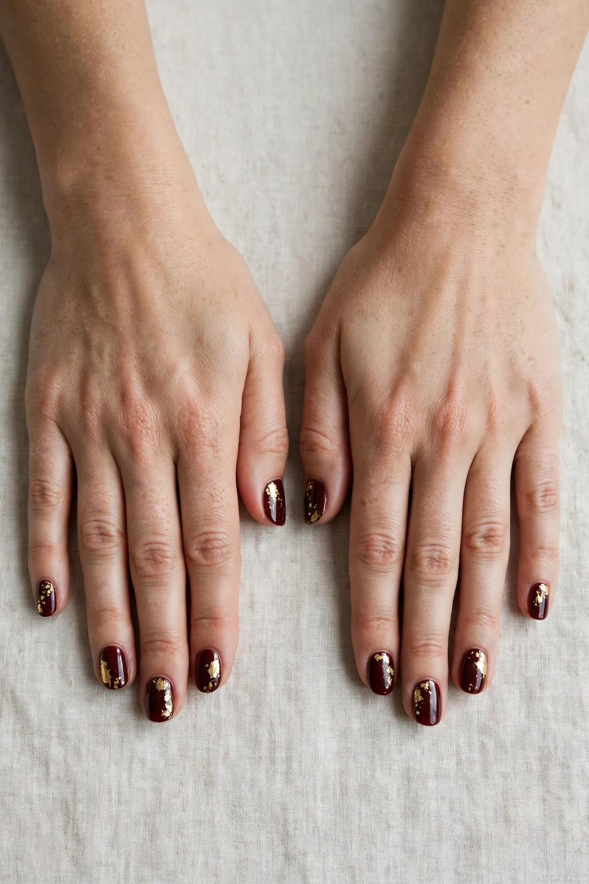 20 Cherry Cola Glossy Nails For Deep Winter Evenings That Are Chic, Warm and Elegant 2 Short Oval Cherry Cola Glossy Nails with a high-gloss finish and gold foil accents