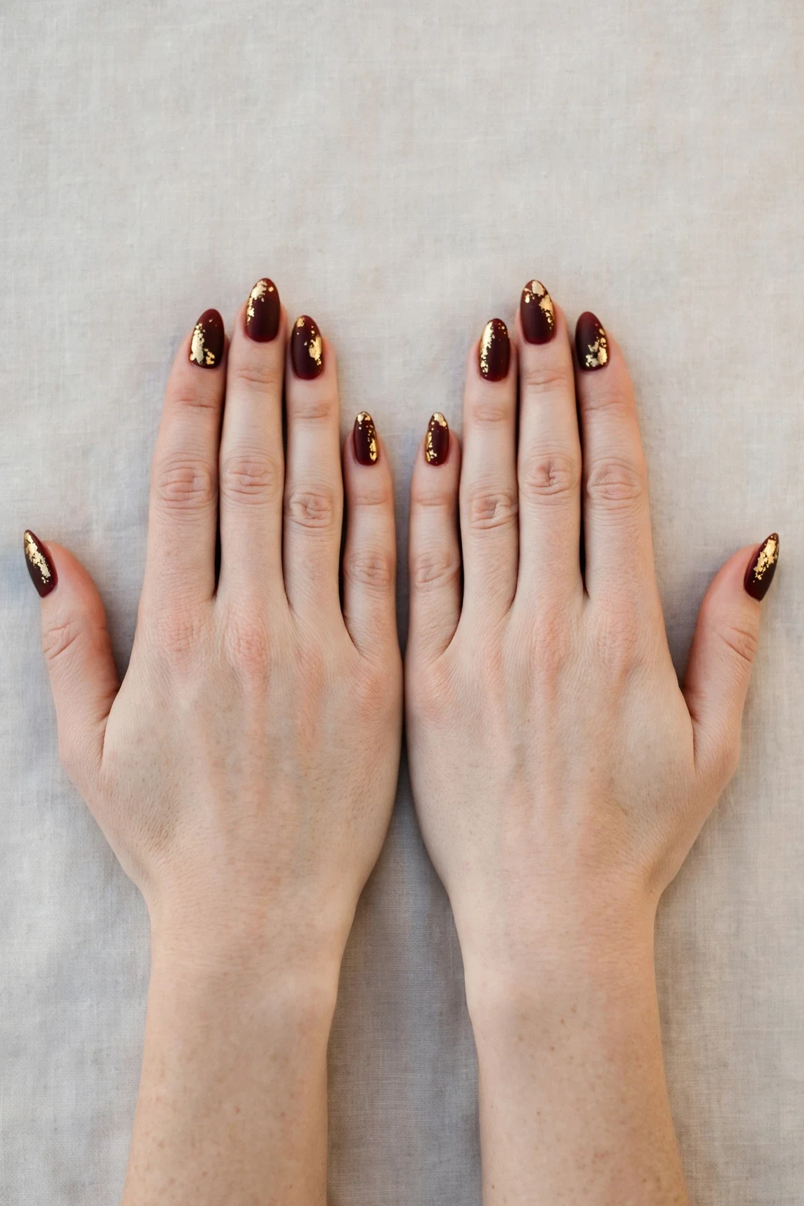 20 Cherry Cola Glossy Nails For Deep Winter Evenings That Are Chic, Warm and Elegant 3 Almond Cherry Cola Glossy Nails with a soft matte finish and gold foil accents