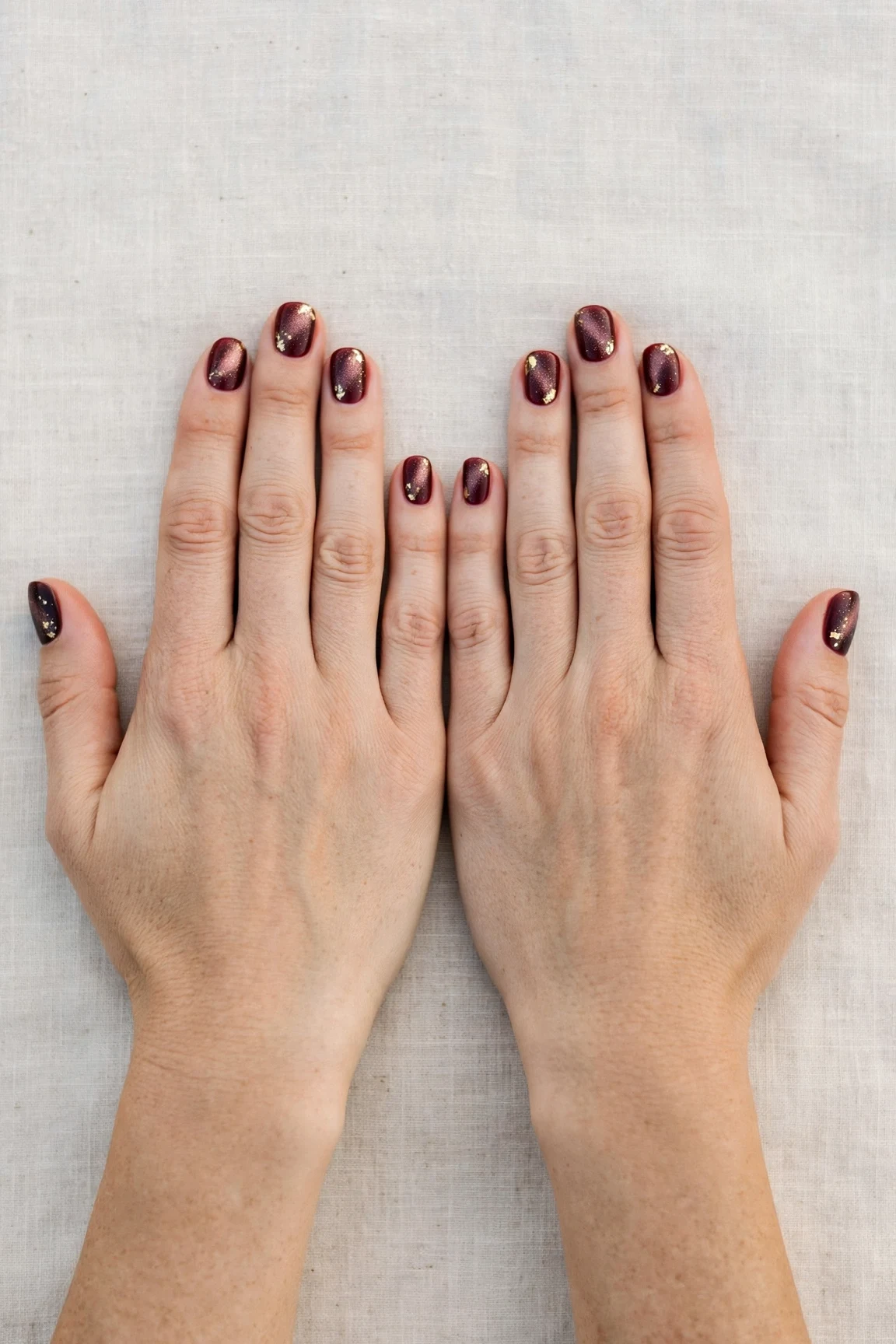 20 Cherry Cola Glossy Nails For Deep Winter Evenings That Are Chic, Warm and Elegant 7 Short Round Cherry Cola Glossy Nails with a frosted shimmer finish and gold foil accents