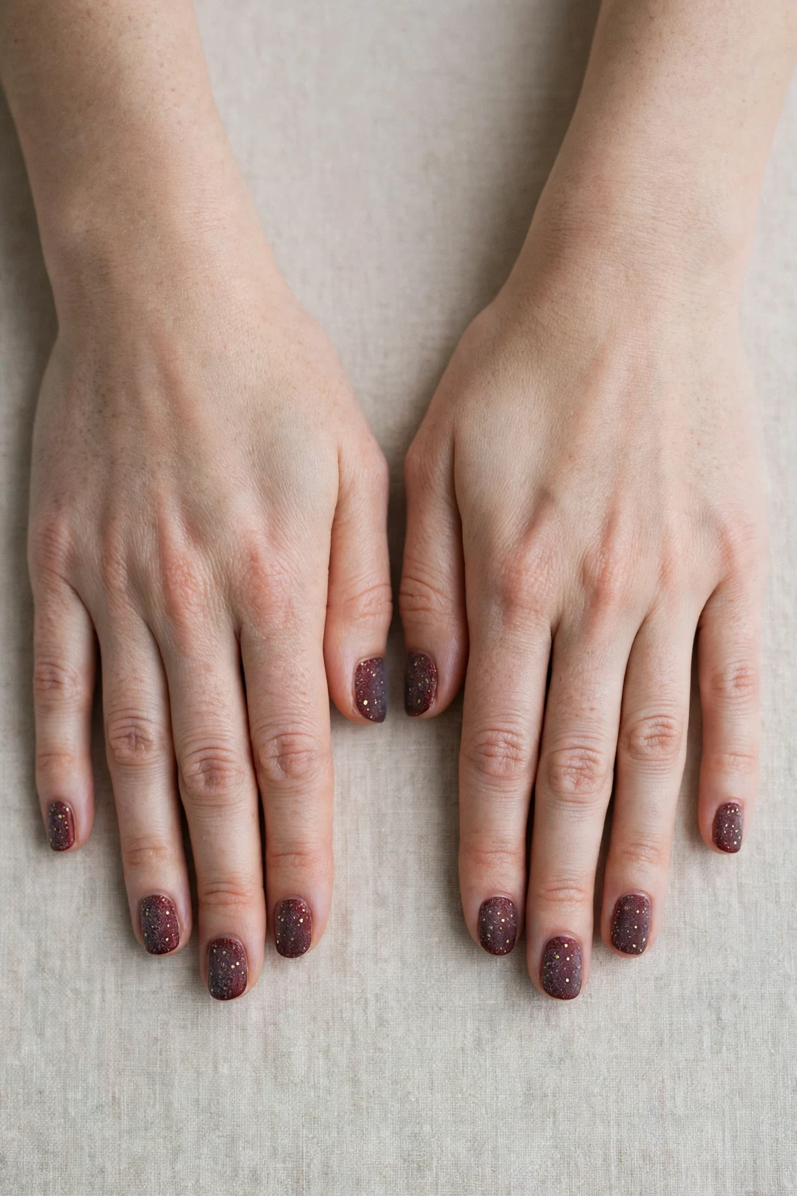 20 Cherry Cola Glossy Nails For Deep Winter Evenings That Are Chic, Warm and Elegant 19 Short Round Cherry Cola Glossy Nails with a frosted shimmer finish and tiny gold dots