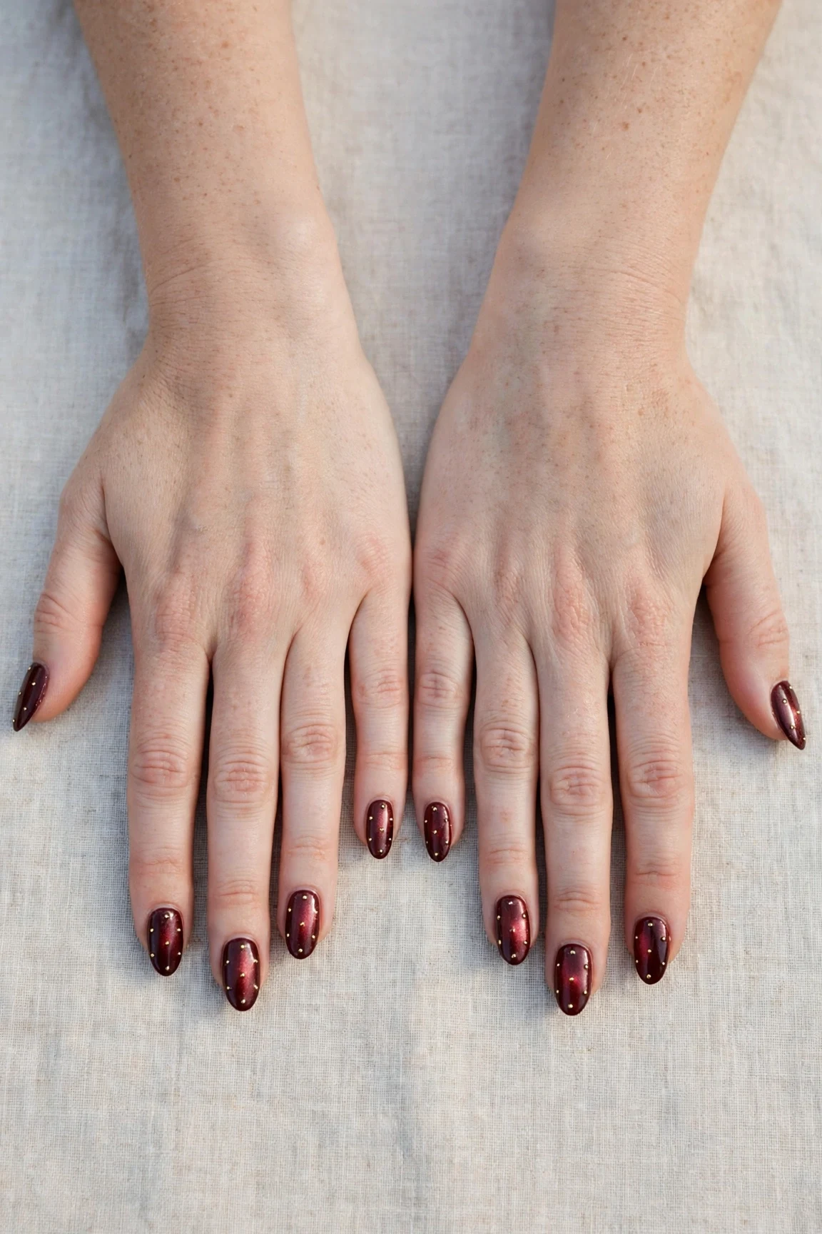 20 Cherry Cola Glossy Nails For Deep Winter Evenings That Are Chic, Warm and Elegant 21 Almond Cherry Cola Glossy Nails with a pearl shimmer finish and tiny gold dots