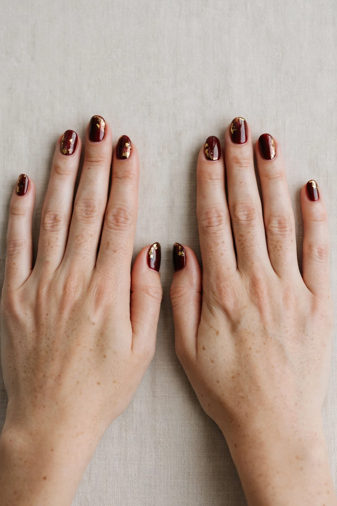 25 Cherry Cola Nail Designs With Gold Accents For Winter Weddings That Are Chic, Warm and Elegant 2 Short Oval Cherry Cola Nail Designs with Gold Accents with a high-gloss finish and gold foil accents