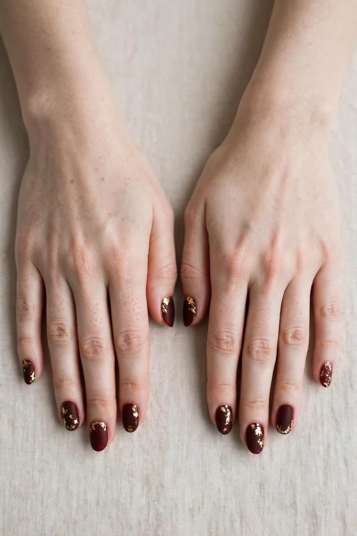 25 Cherry Cola Nail Designs With Gold Accents For Winter Weddings That Are Chic, Warm and Elegant 4 Oval Cherry Cola Nail Designs with Gold Accents with a velvet matte finish and gold foil accents