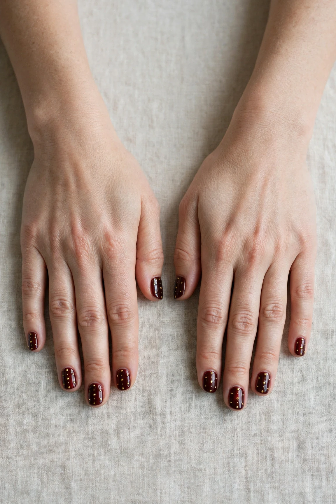 25 Cherry Cola Nail Designs With Gold Accents For Winter Weddings That Are Chic, Warm and Elegant 17 Short Square Cherry Cola Nail Designs with Gold Accents with a chrome shine and tiny gold dots
