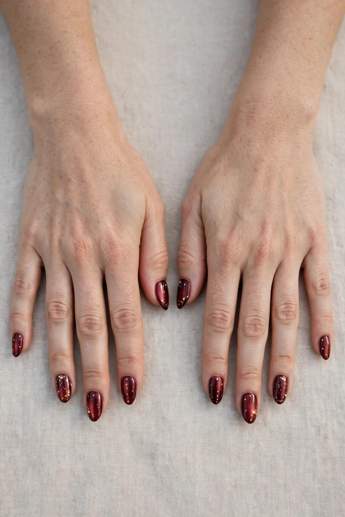 25 Cherry Cola Nail Designs With Gold Accents For Winter Weddings That Are Chic, Warm and Elegant 21 Almond Cherry Cola Nail Designs with Gold Accents with a pearl shimmer finish and tiny gold dots