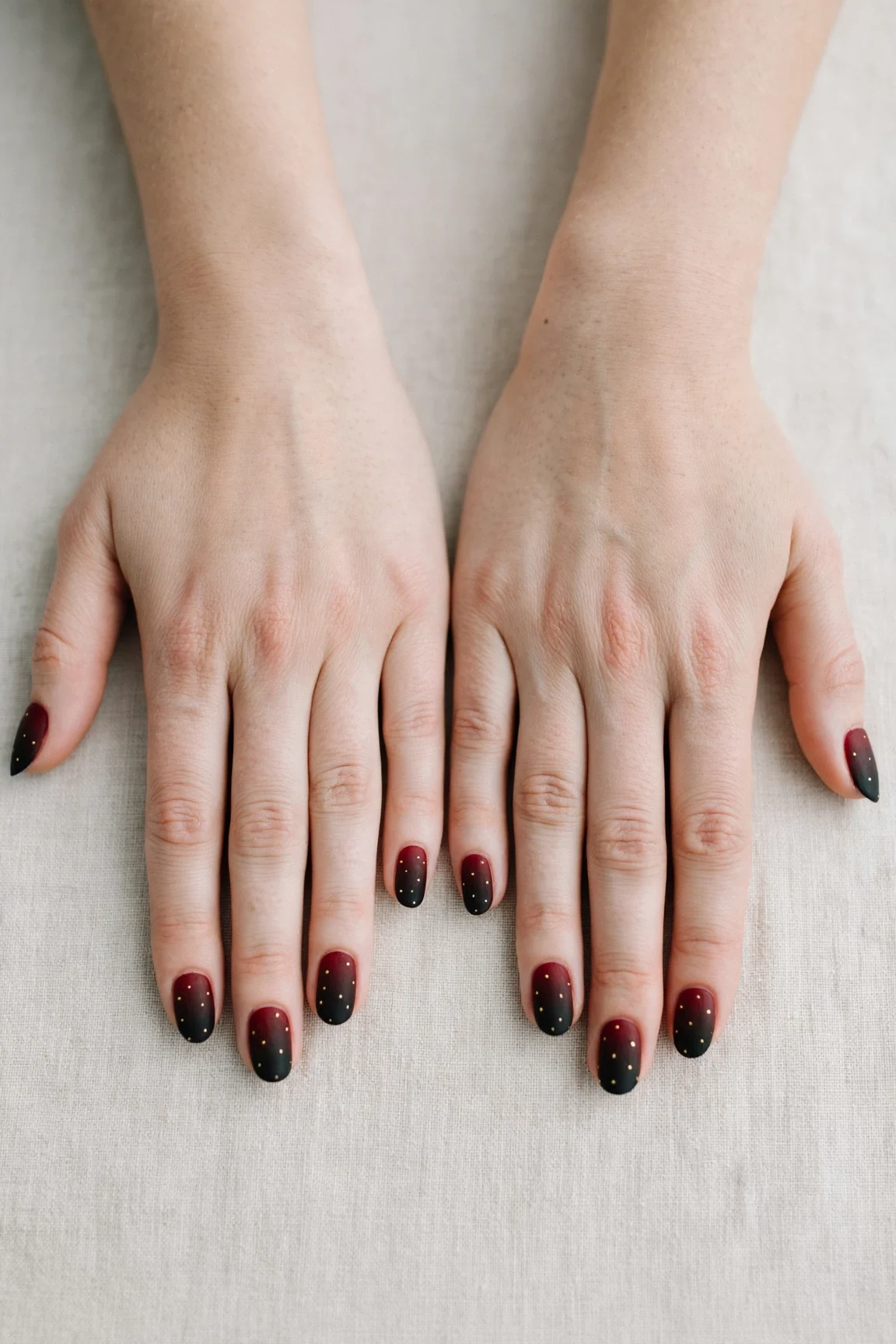 Oval Cherry Cola Ombre Nails with a velvet matte finish and tiny gold dots
