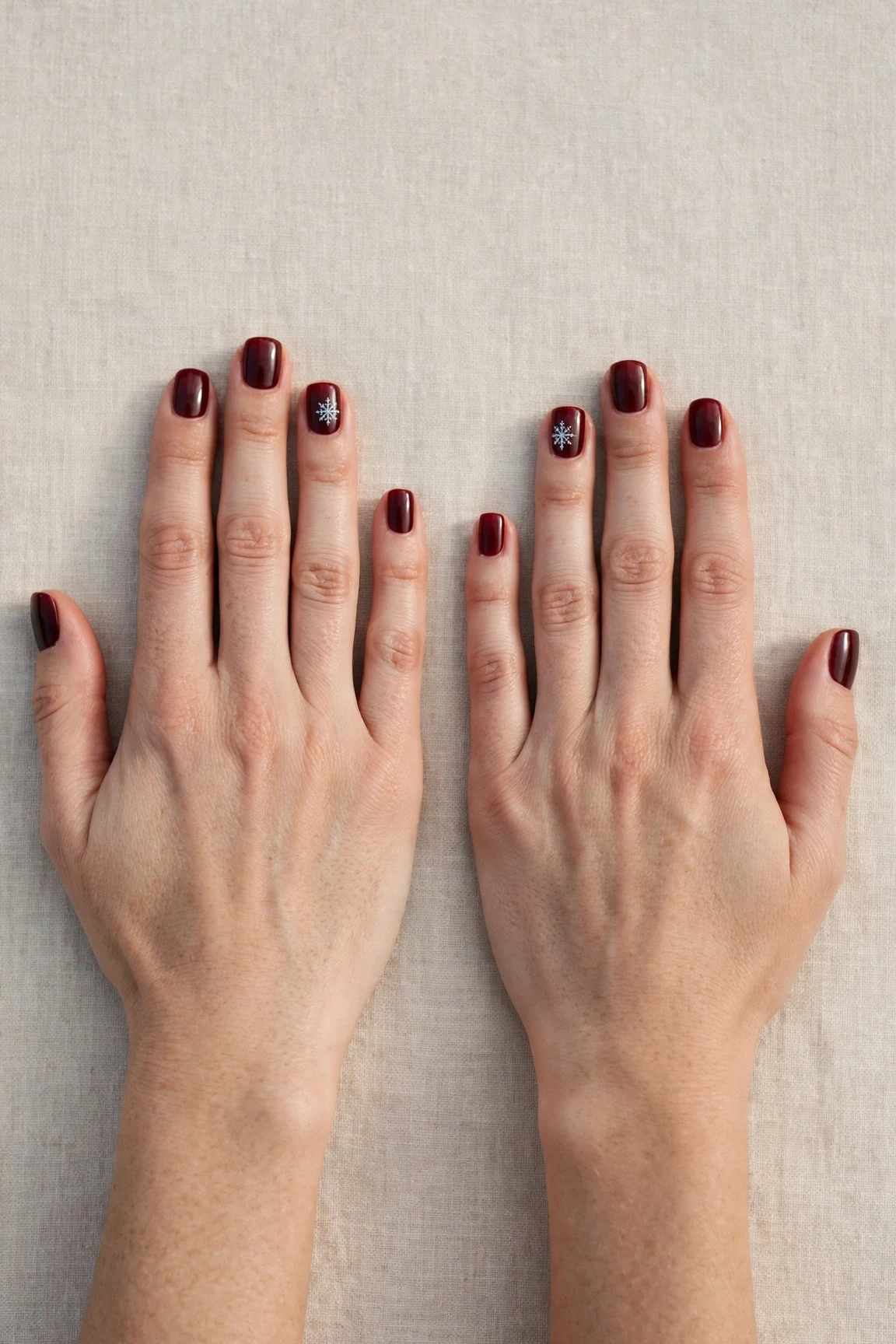 38 Cherry Cola Short Square Nails For January Office Wear That Are Chic, Warm and Elegant 37 Cherry Cola Short Square Nails with a deep glossy shine and a delicate snowflake on the ring finger