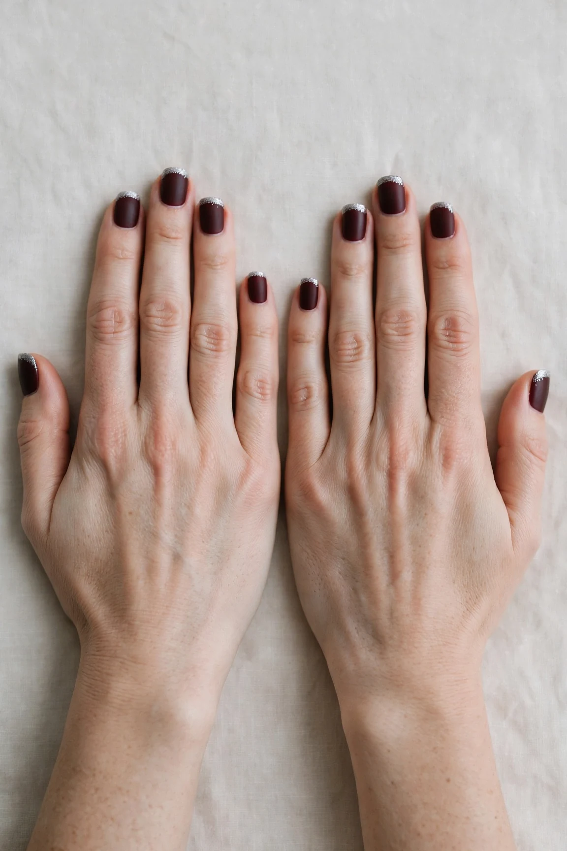 38 Cherry Cola Short Square Nails For January Office Wear That Are Chic, Warm and Elegant 39 Cherry Cola Short Square Nails with a soft matte finish and silver shimmer tips