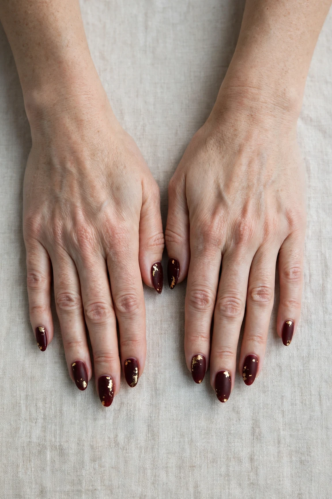 Almond Cherry Cola Velvet Finish Nails with a soft matte finish and gold foil accents
