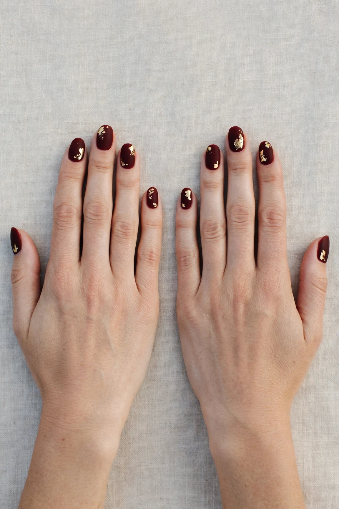 Oval Cherry Cola Velvet Finish Nails with a velvet matte finish and gold foil accents
