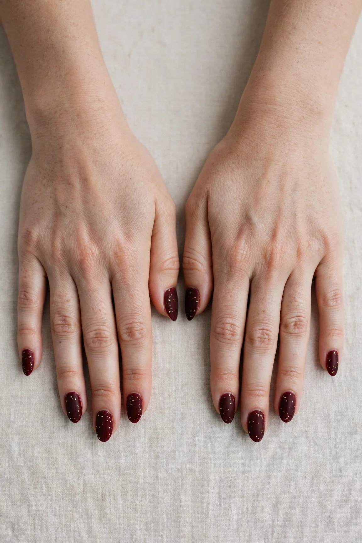 Almond Cherry Cola Velvet Finish Nails with a soft matte finish and tiny gold dots