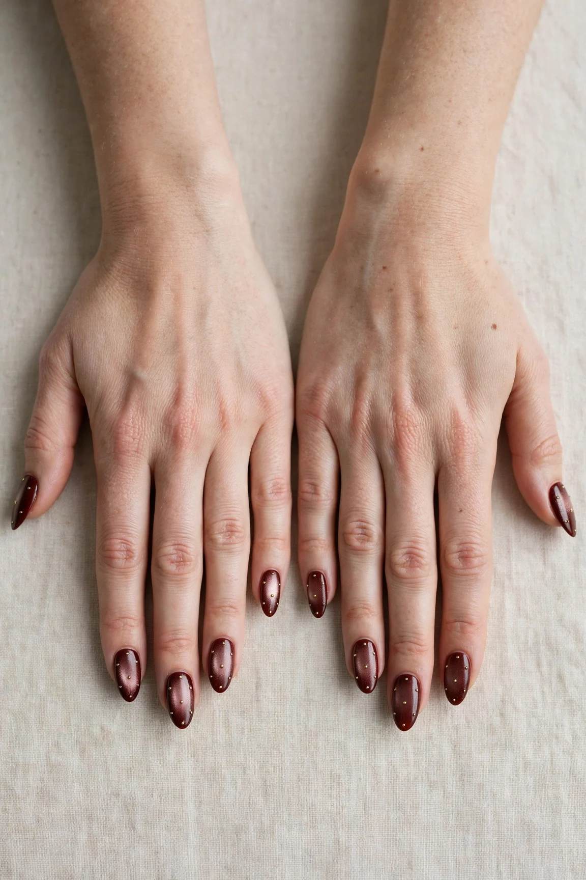 Almond Cherry Cola Velvet Finish Nails with a pearl shimmer finish and tiny gold dots