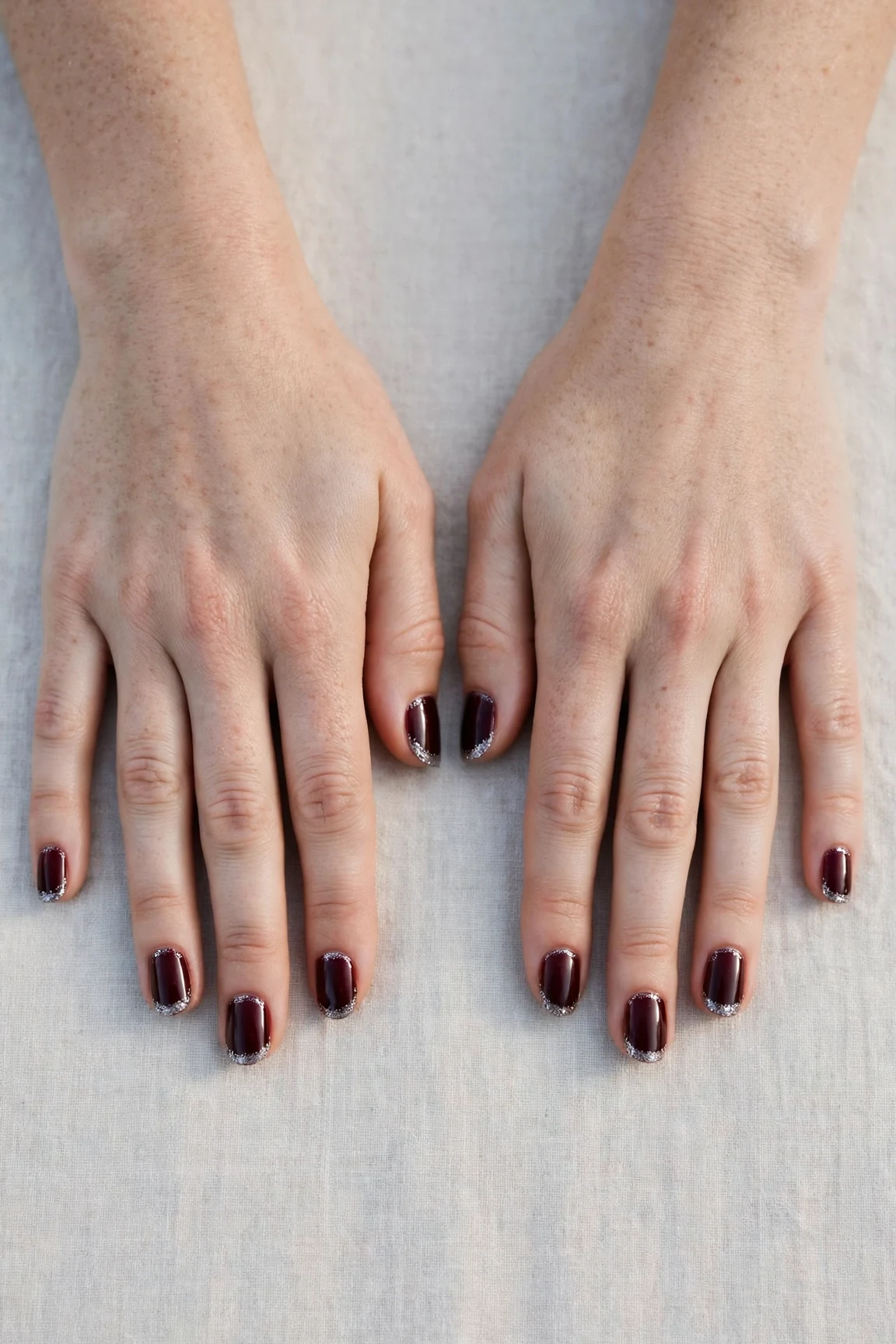Short Round Cherry Cola Velvet Finish Nails with a deep glossy shine and silver shimmer tips