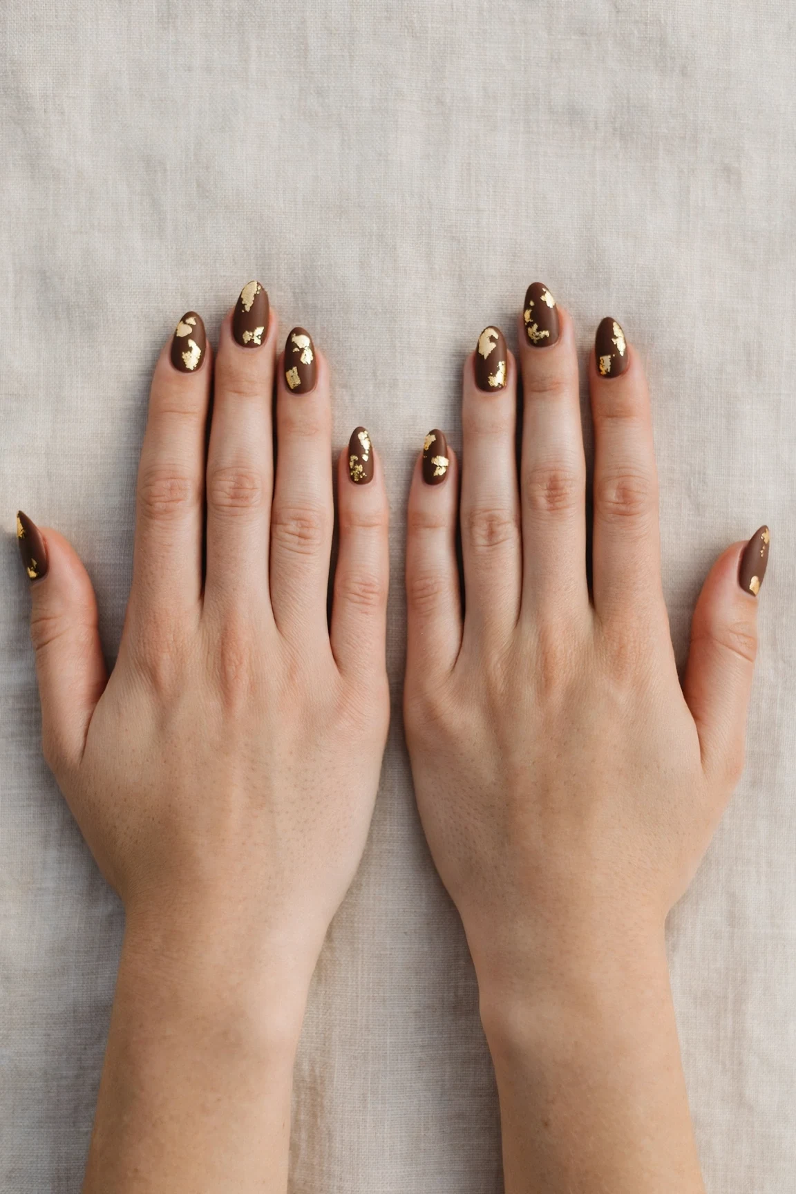 Almond Chocolate Brown Christmas Nail Art with a soft matte finish and gold foil accents