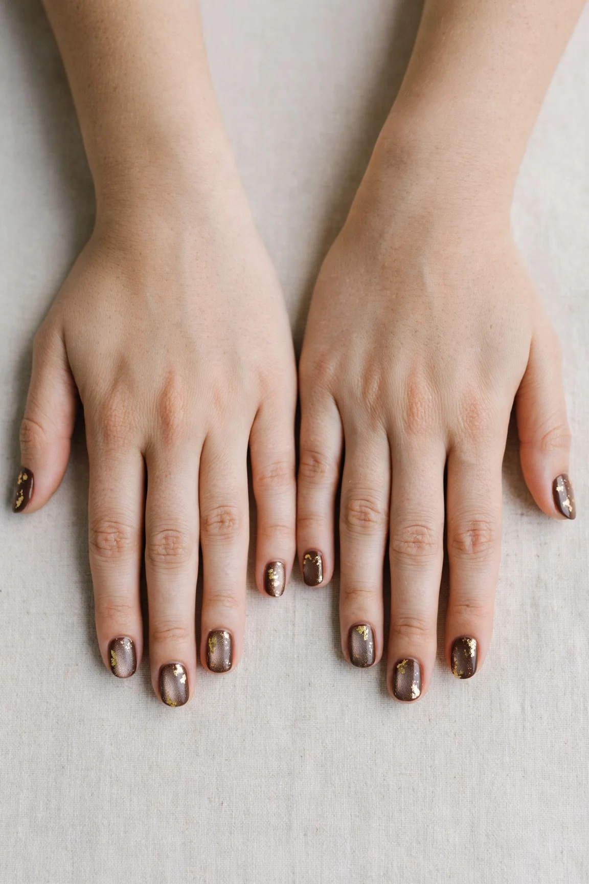 Short Round Chocolate Brown Christmas Nail Art with a frosted shimmer finish and gold foil accents