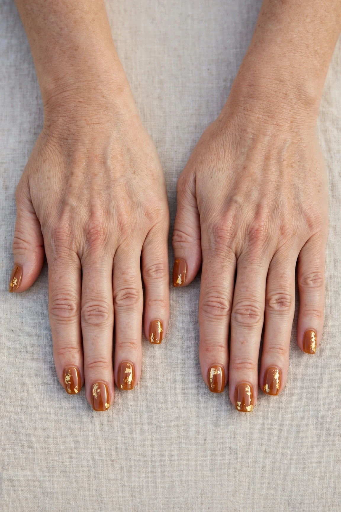 Squoval Cinnamon Caramel Nail Art with a sheer jelly finish and gold foil accents