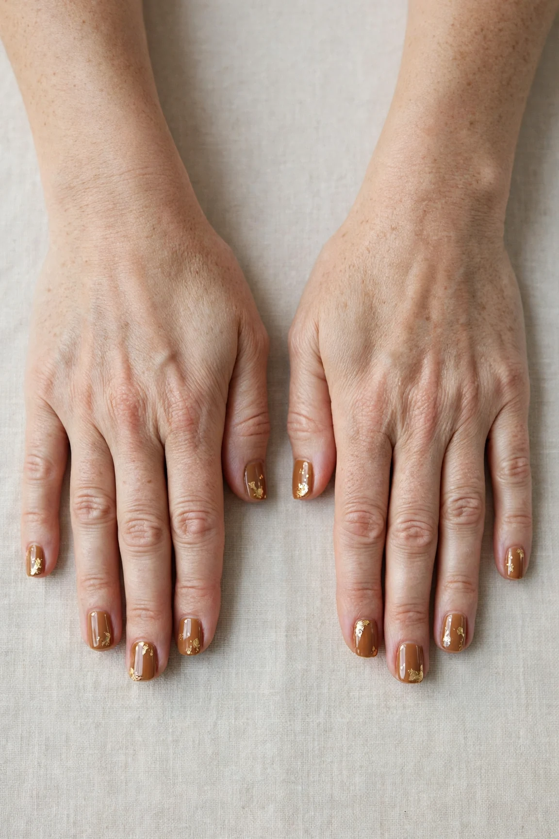 Short Square Cinnamon Caramel Nail Art with a glassy gel finish and gold foil accents