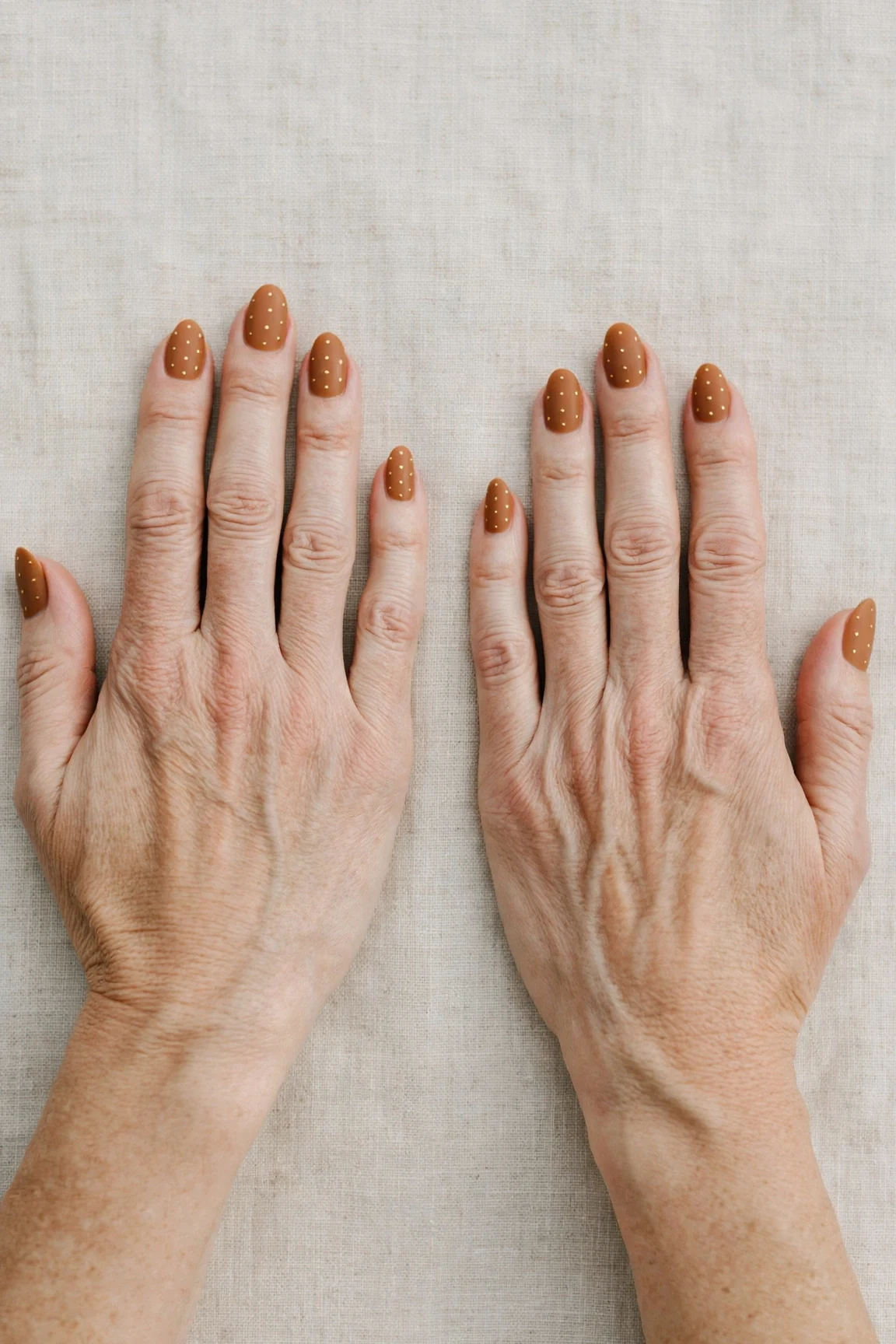 Almond Cinnamon Caramel Nail Art with a soft matte finish and tiny gold dots