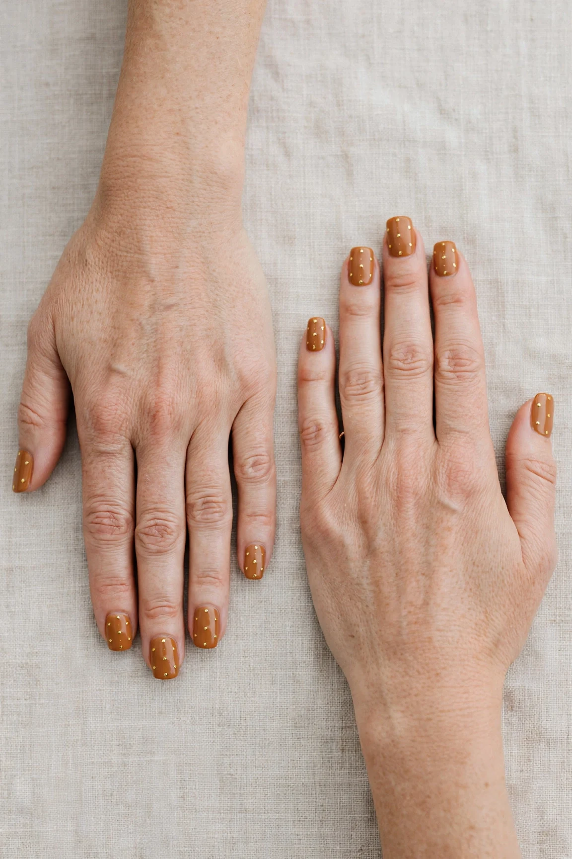 Squoval Cinnamon Caramel Nail Art with a creamy opaque finish and tiny gold dots