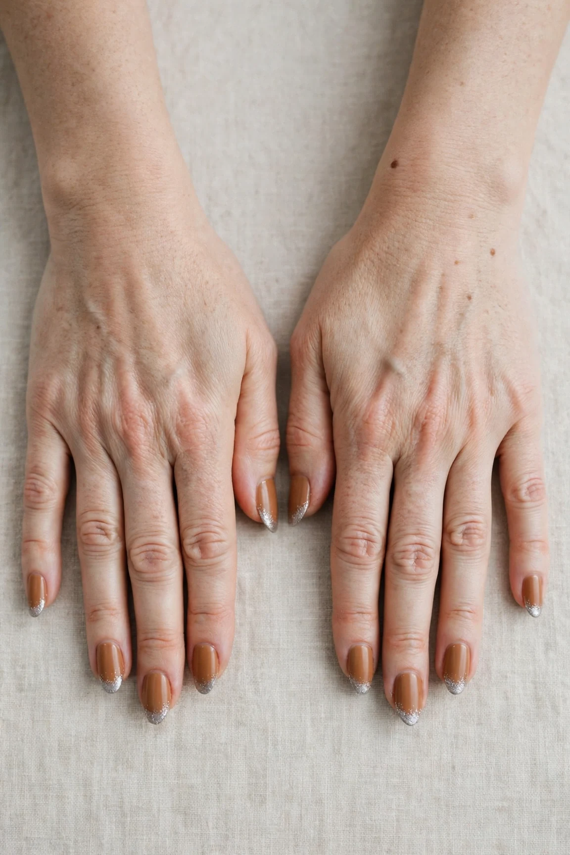 Almond Cinnamon Caramel Nail Art with a soft matte finish and silver shimmer tips