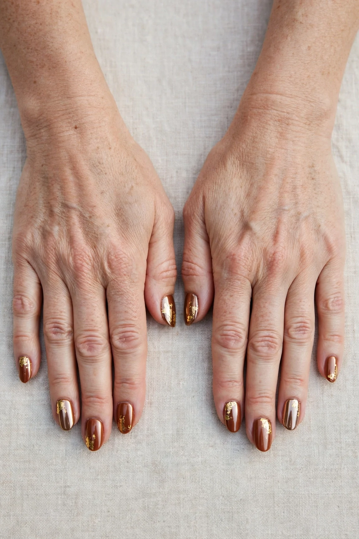Cinnamon Spice Almond Nails with a chrome shine and gold foil accents