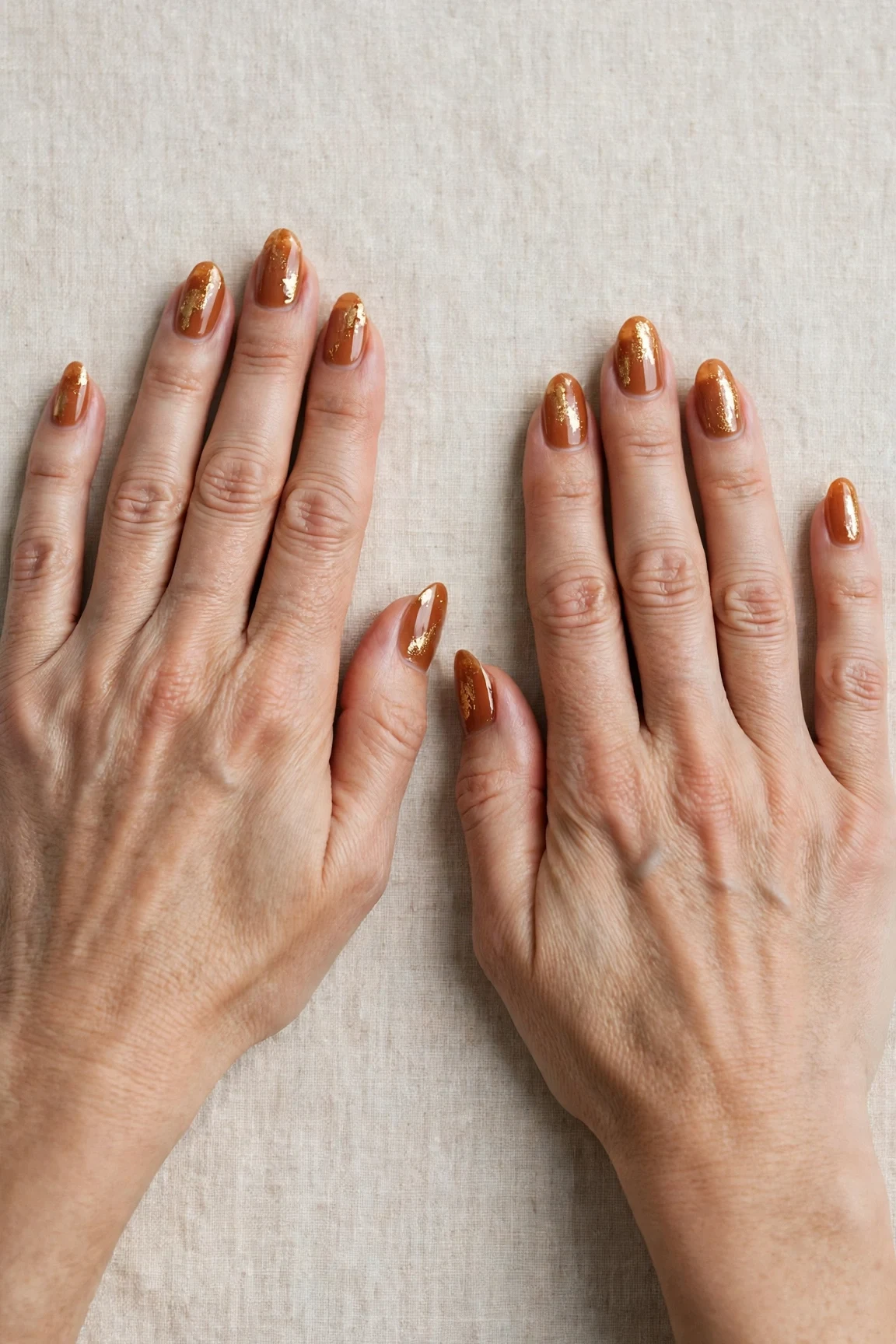 Cinnamon Spice Almond Nails with a sheer jelly finish and gold foil accents