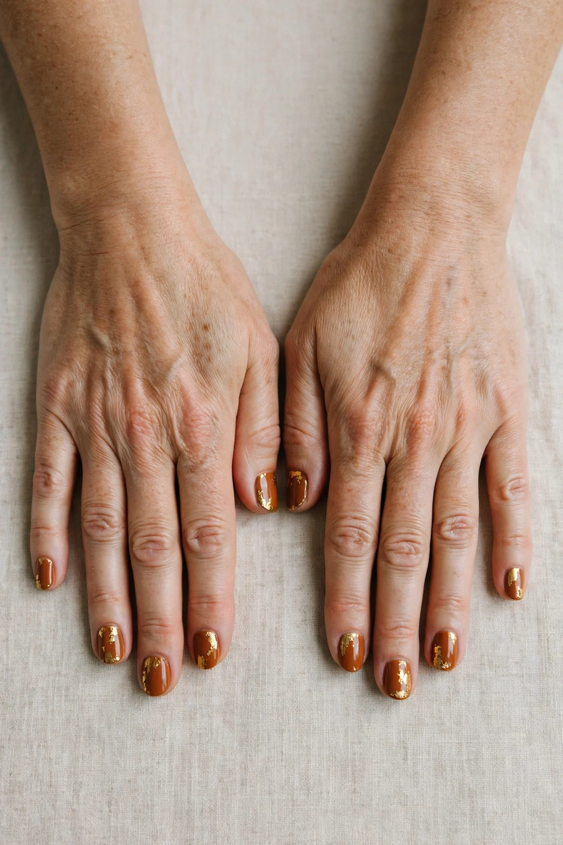 22 Cinnamon Spice Matte Nails For Women Over 40 For January Parties That Are Chic, Warm and Elegant 2 Short Oval Cinnamon Spice Matte Nails with a high-gloss finish and gold foil accents