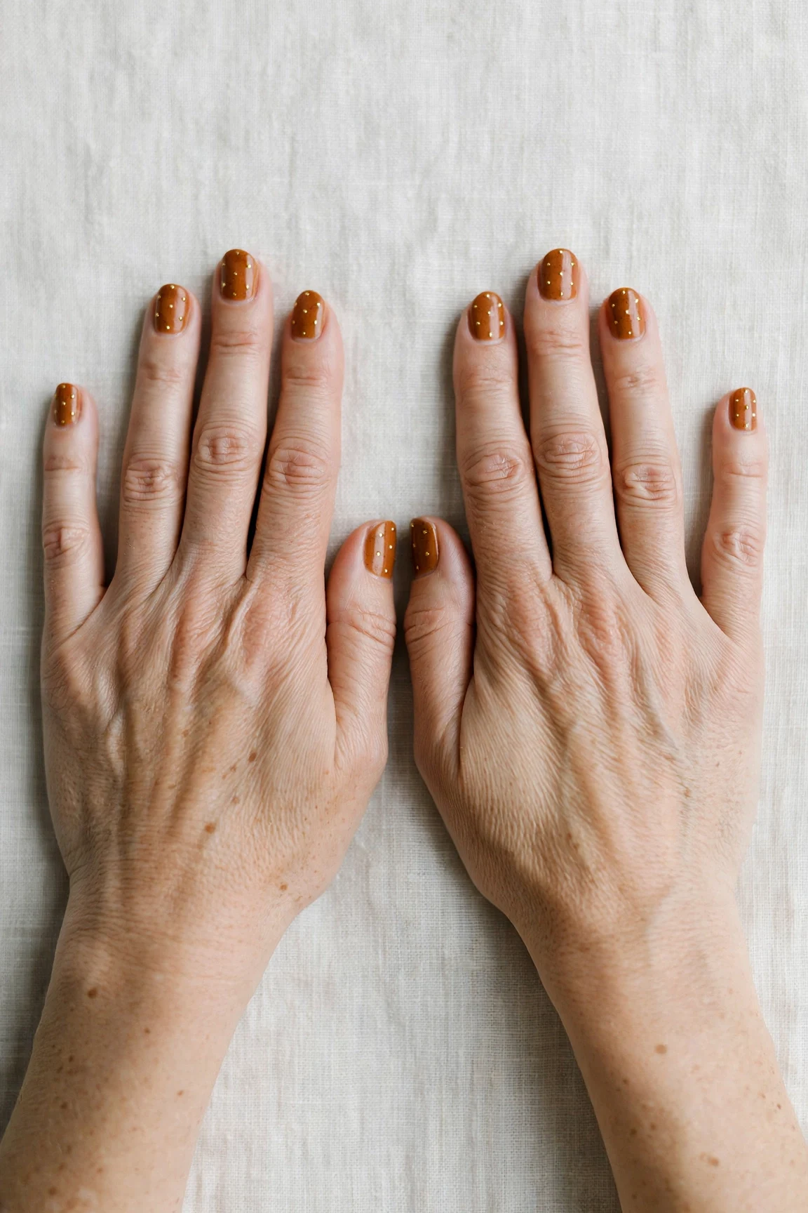 22 Cinnamon Spice Matte Nails For Women Over 40 For January Parties That Are Chic, Warm and Elegant 14 Short Oval Cinnamon Spice Matte Nails with a high-gloss finish and tiny gold dots