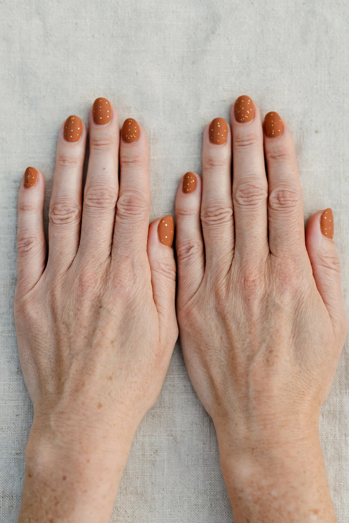 22 Cinnamon Spice Matte Nails For Women Over 40 For January Parties That Are Chic, Warm and Elegant 16 Oval Cinnamon Spice Matte Nails with a velvet matte finish and tiny gold dots