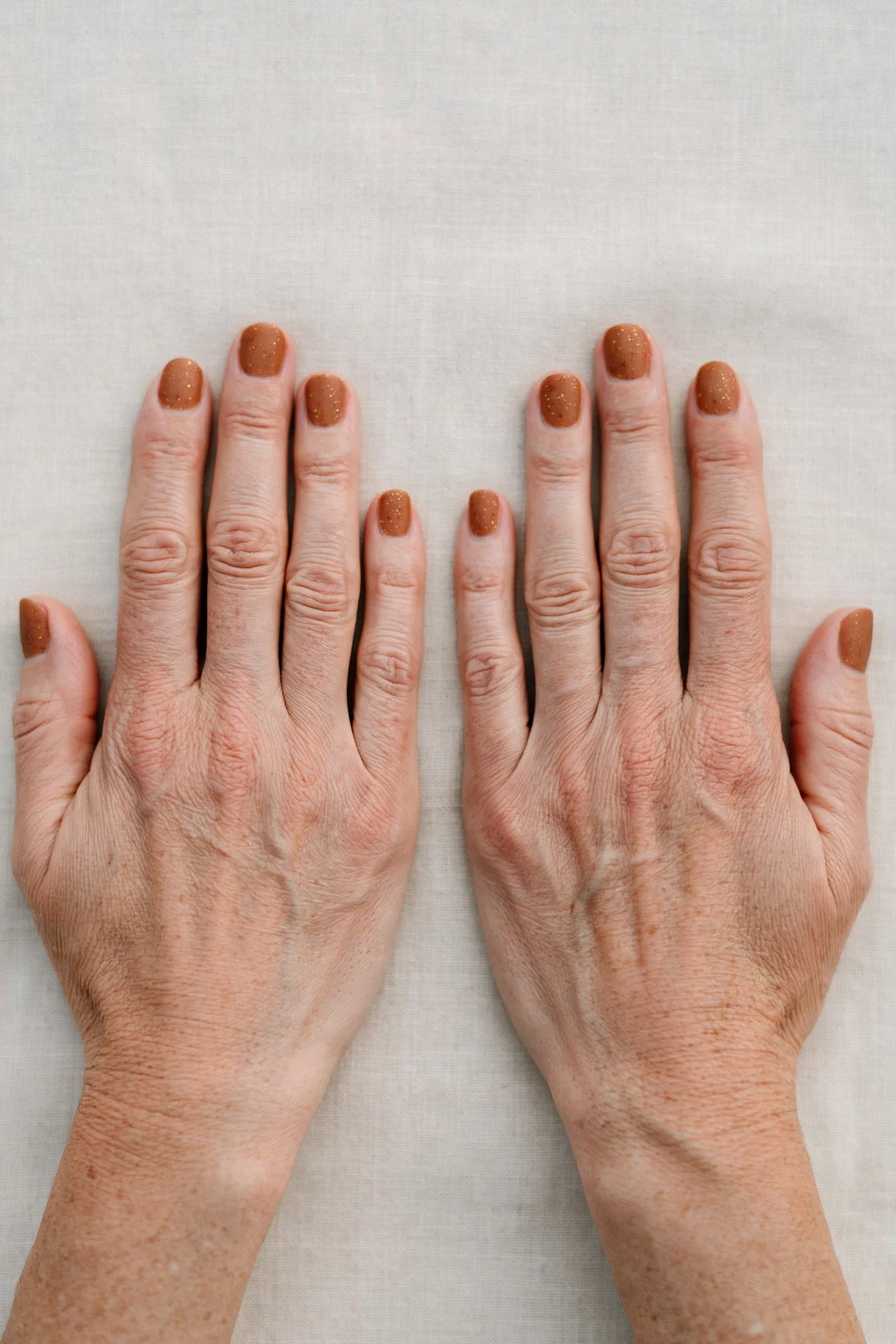 22 Cinnamon Spice Matte Nails For Women Over 40 For January Parties That Are Chic, Warm and Elegant 19 Short Round Cinnamon Spice Matte Nails with a frosted shimmer finish and tiny gold dots